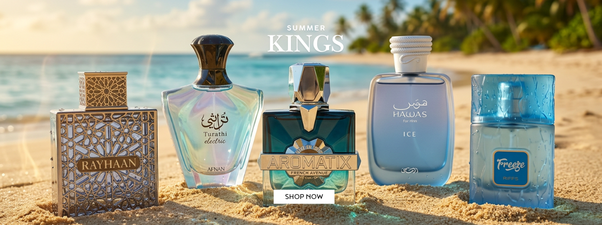 Five Rayyan fragrances displayed on a sandy beach with the ocean and palm trees in the background. The collection includes Rayyan Gold, Rayyan Ice, Rayyan Chill, and two blue Rayyan fragrances, with 'SUMMER KINGS' and a 'SHOP NOW' button at the top. For ScentSaver